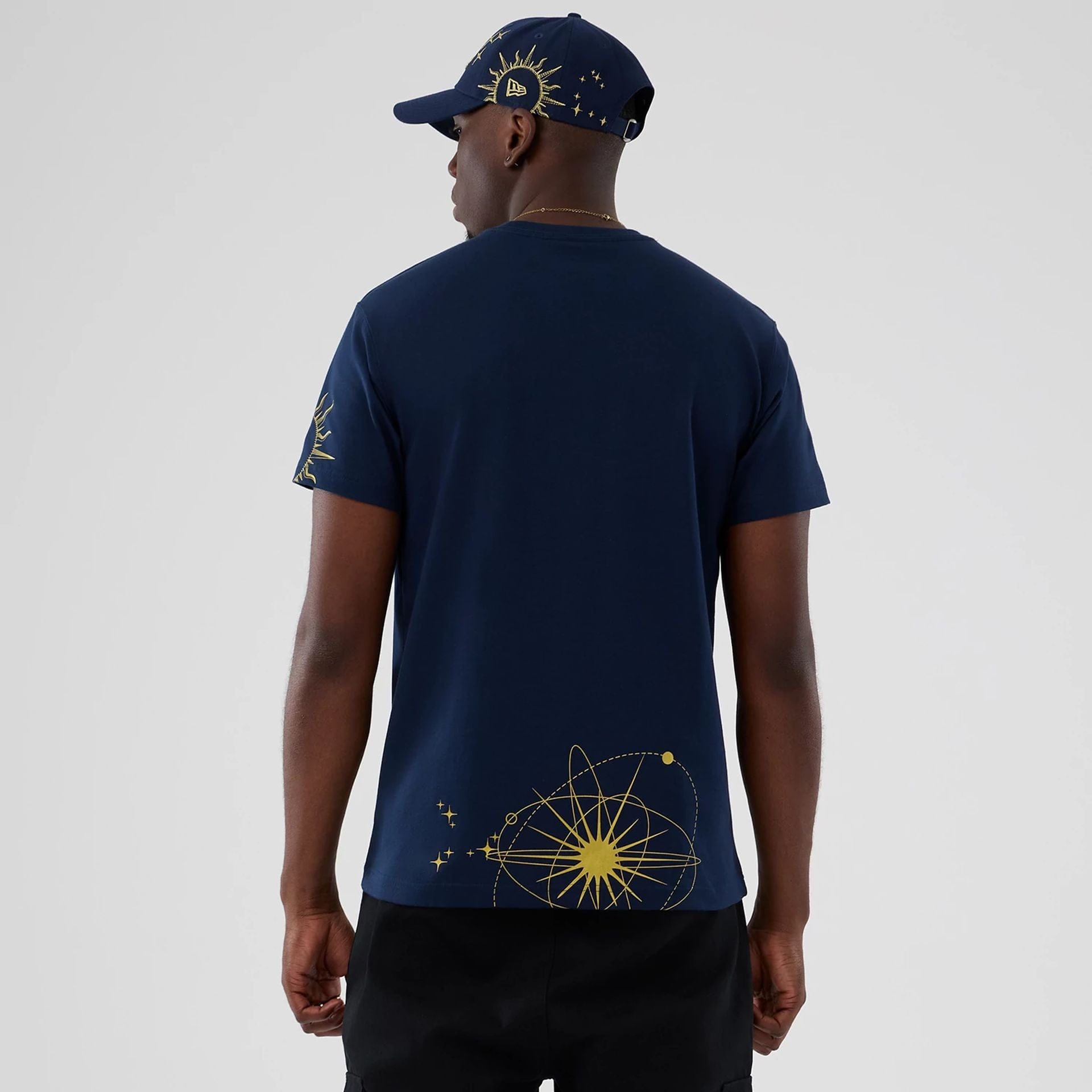 The model is wearing this New Era Cosmic Craft T-Shirt in blue. 2
