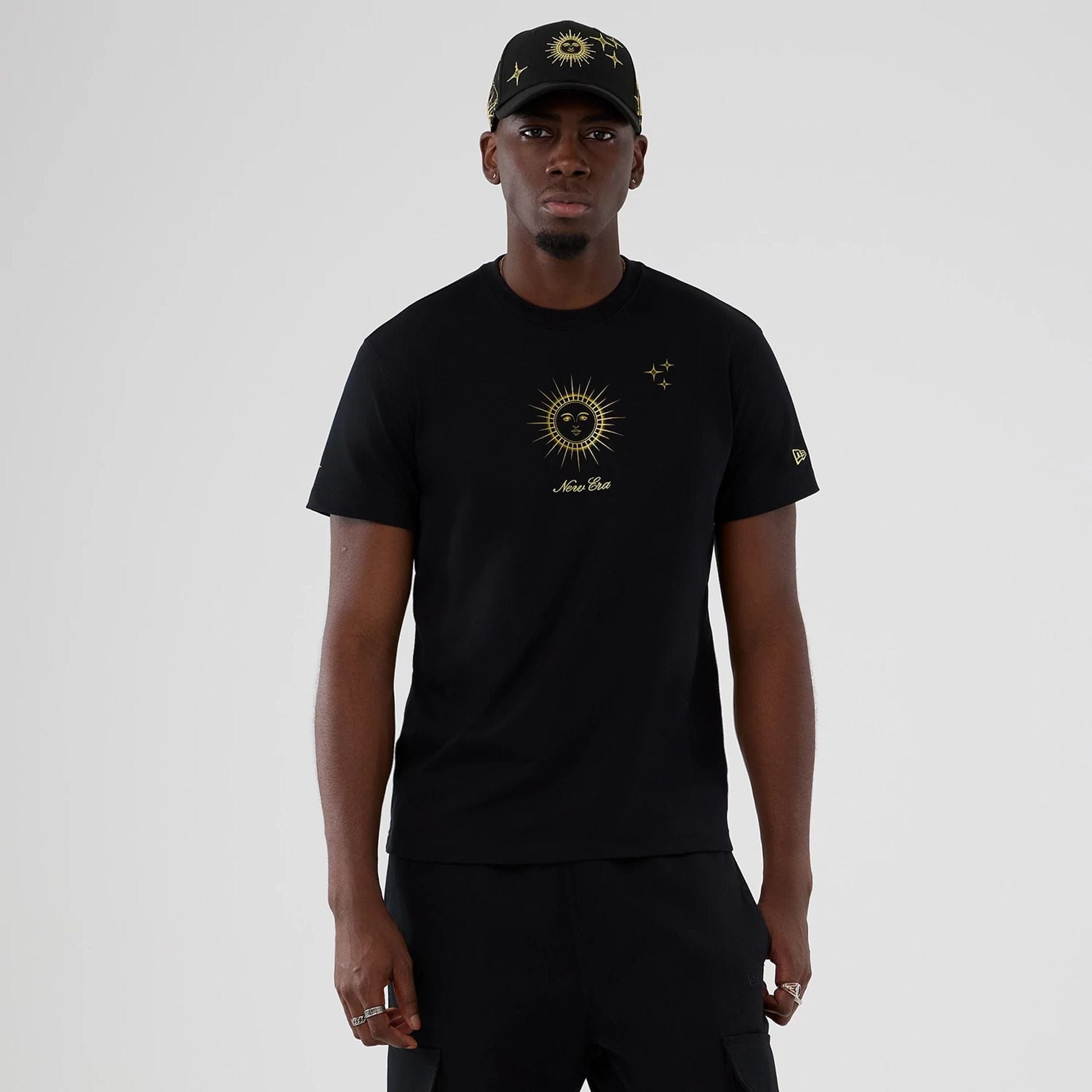 The model is wearing this New Era Cosmic Craft T-Shirt in black. 1