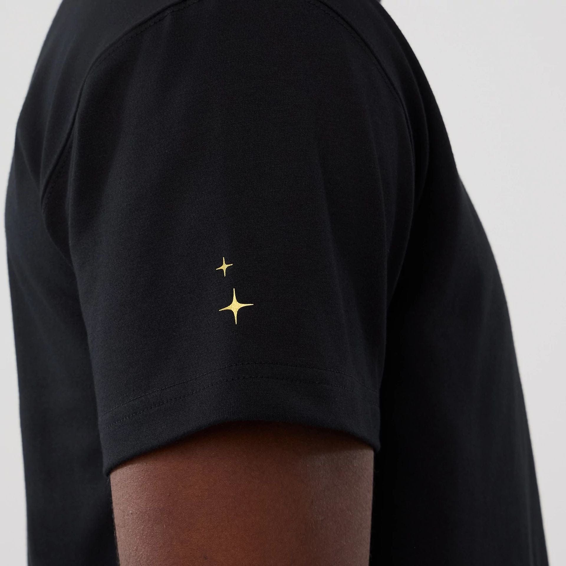 The model is wearing this New Era Cosmic Craft T-Shirt in black. 6