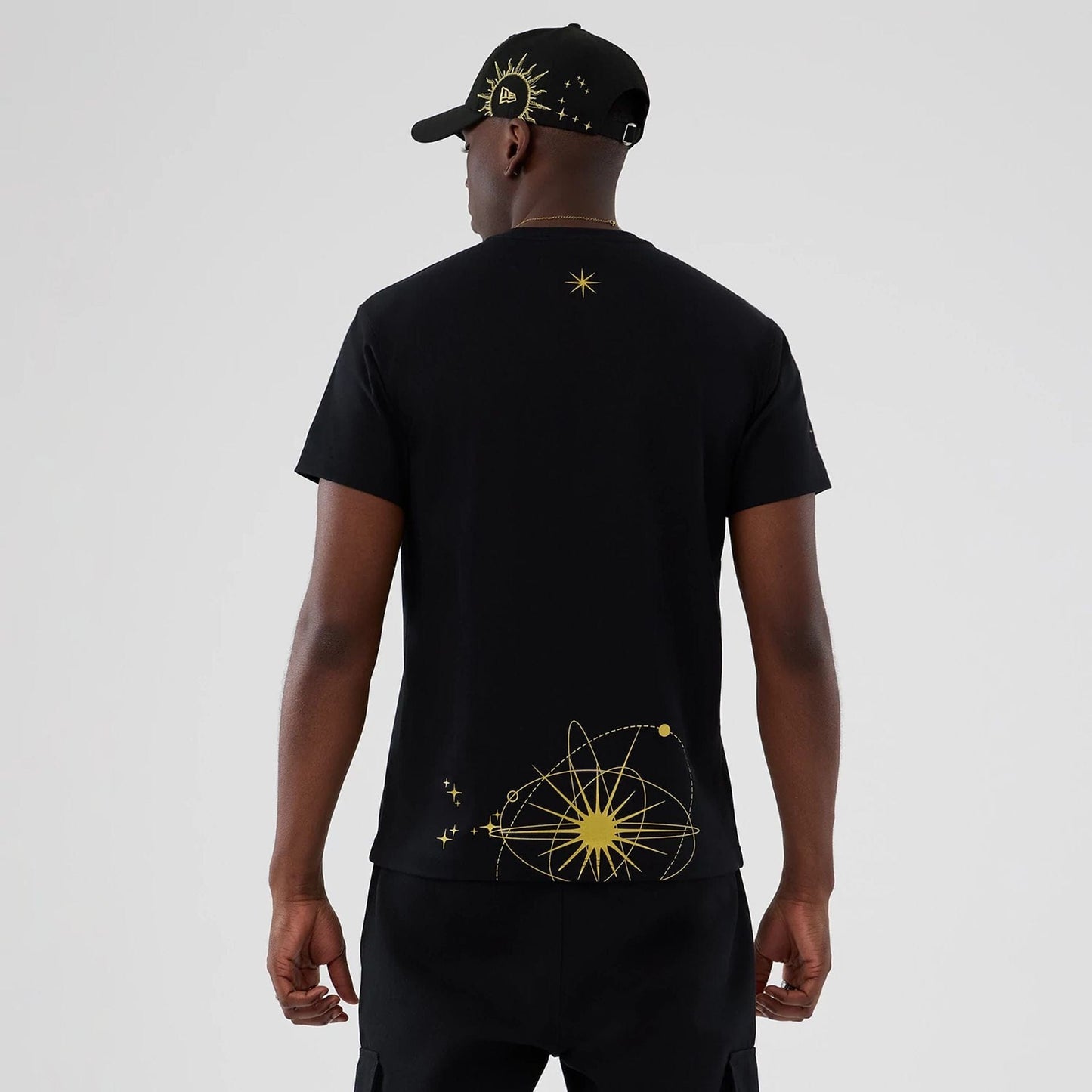 The model is wearing this New Era Cosmic Craft T-Shirt in black. 2