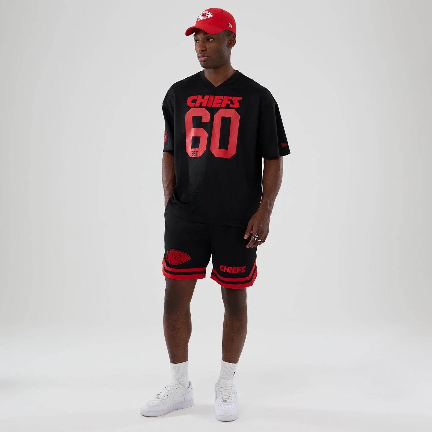 The model is wearing this NFL Historic Kansas City Chiefs Oversized T-Shirt in black. 8
