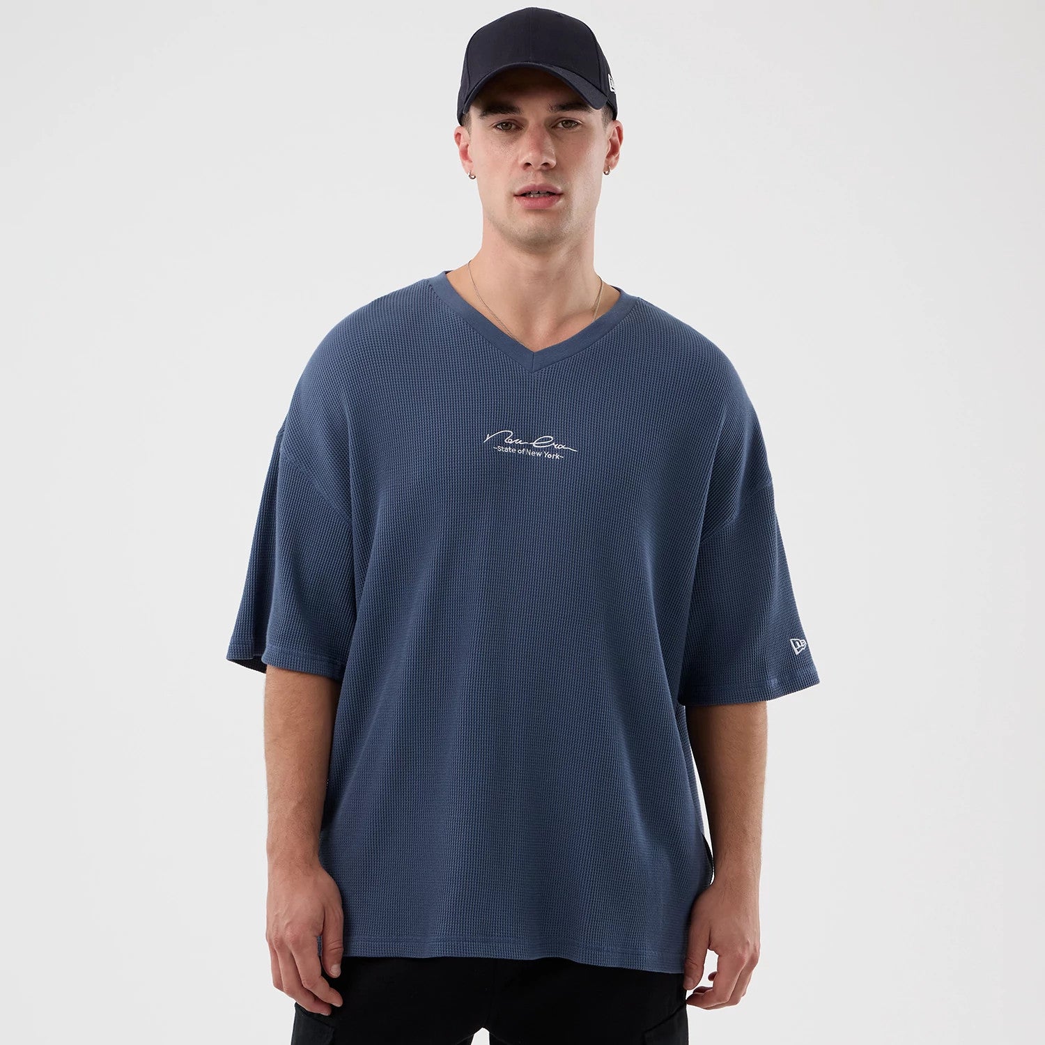 The Male model is wearing New Era Basic Blue T-Shirt 1