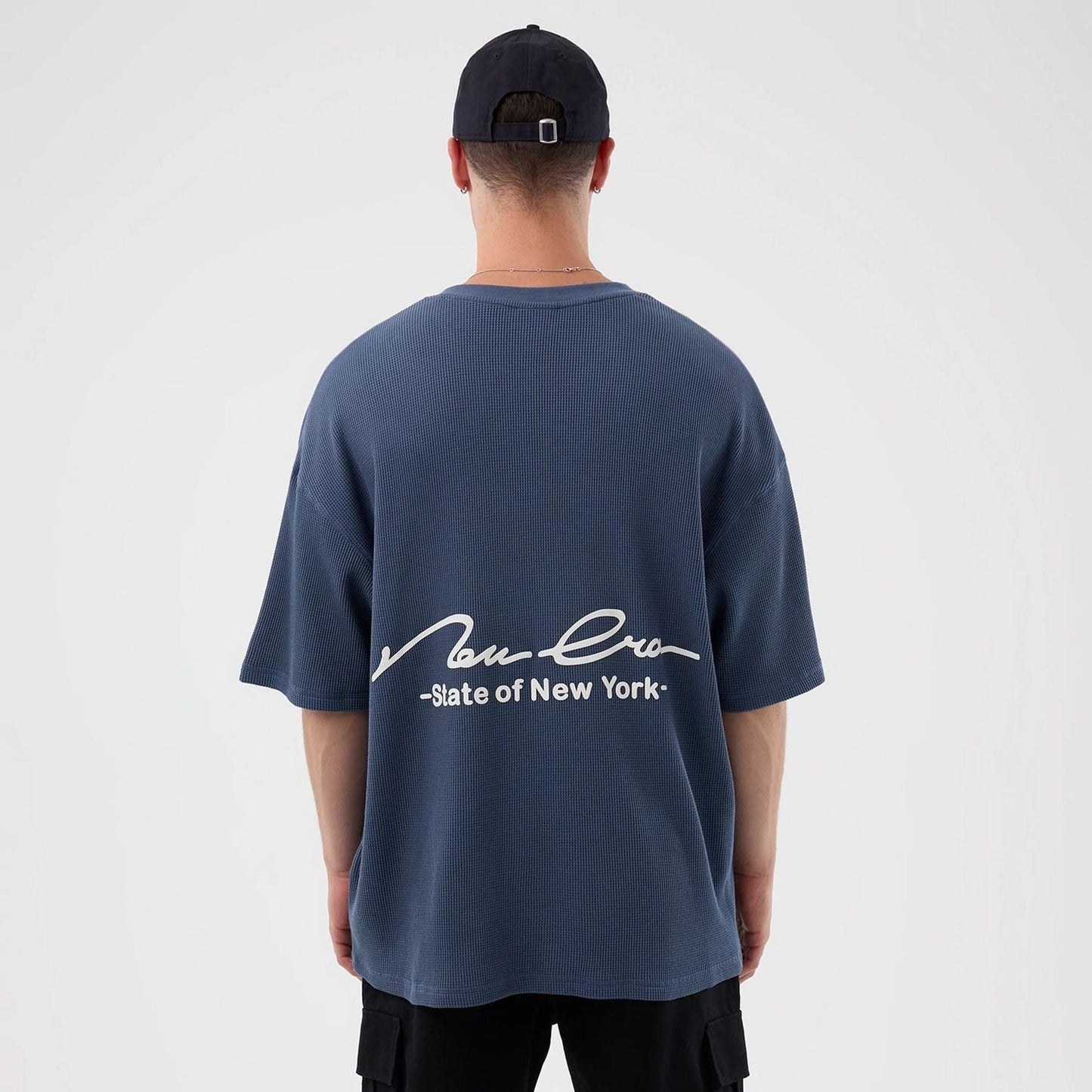 The Male model is wearing New Era Basic Blue T-Shirt 2