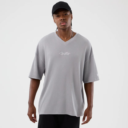 The Male model is wearing New Era Basic Grey T-Shirt 1