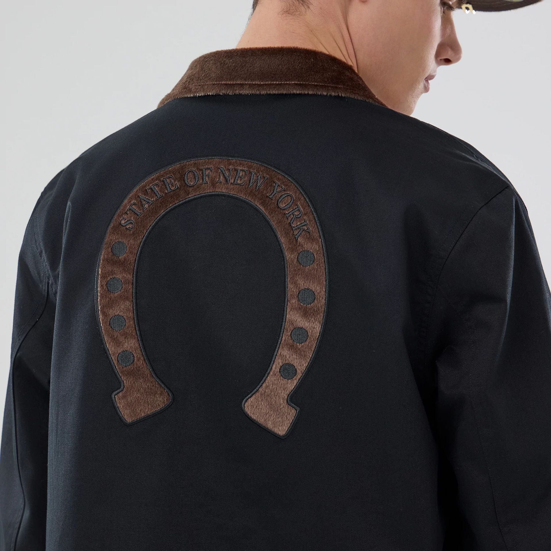 The model is wearing this New Era Year Of The Horse Jacket in black. 3