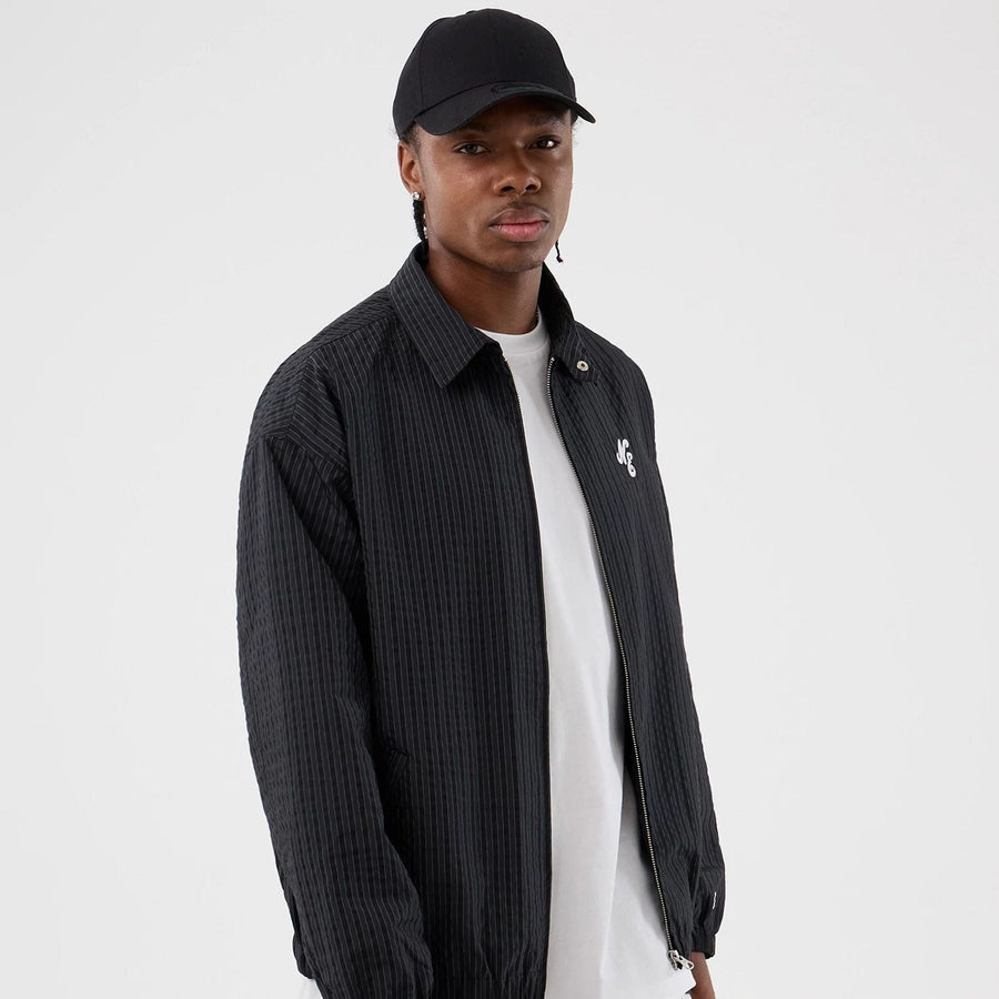 The model is wearing this New Era Street Class jacket in navy. 1