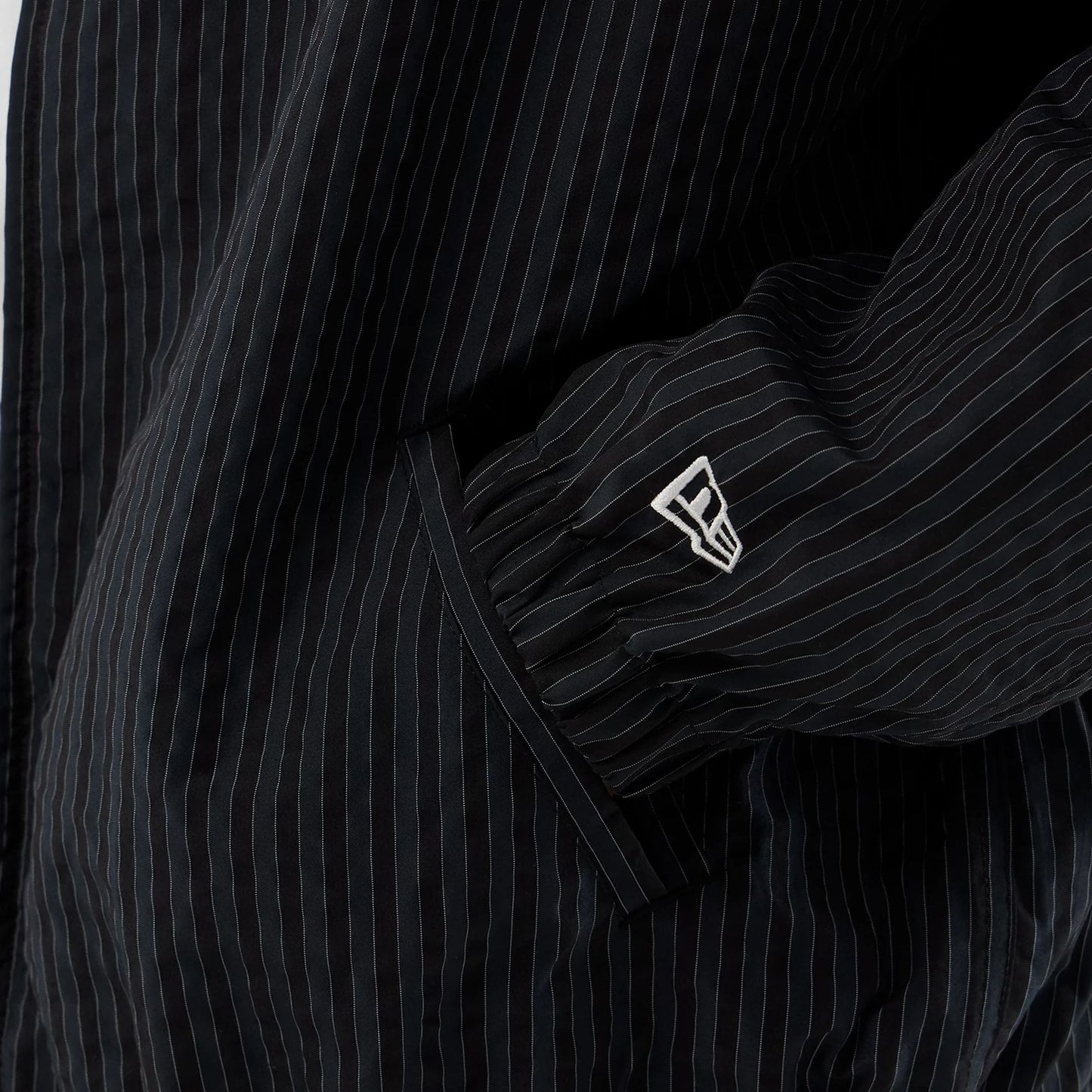 The model is wearing this New Era Street Class jacket in navy. 5