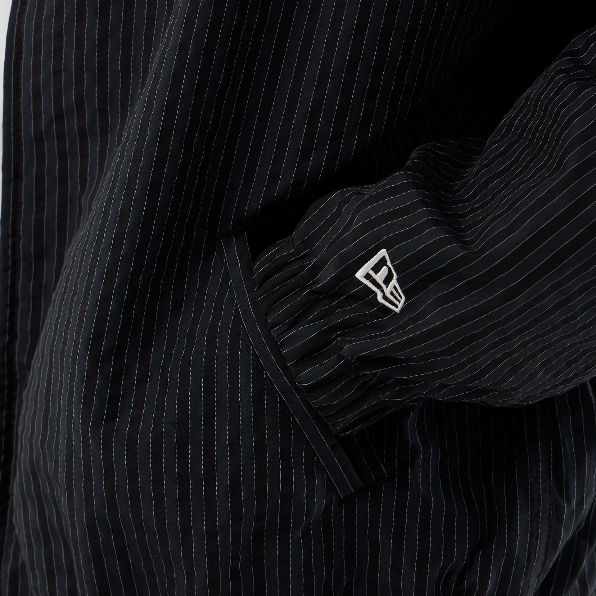 The model is wearing this New Era Street Class jacket in navy. 5