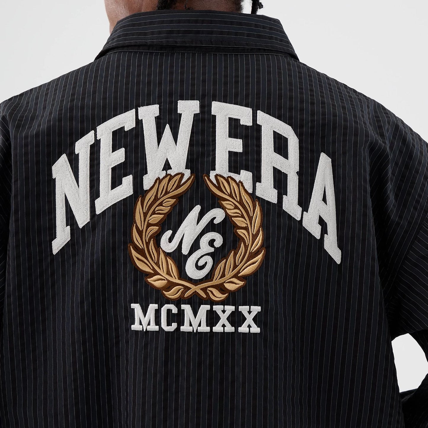 The model is wearing this New Era Street Class jacket in navy. 7