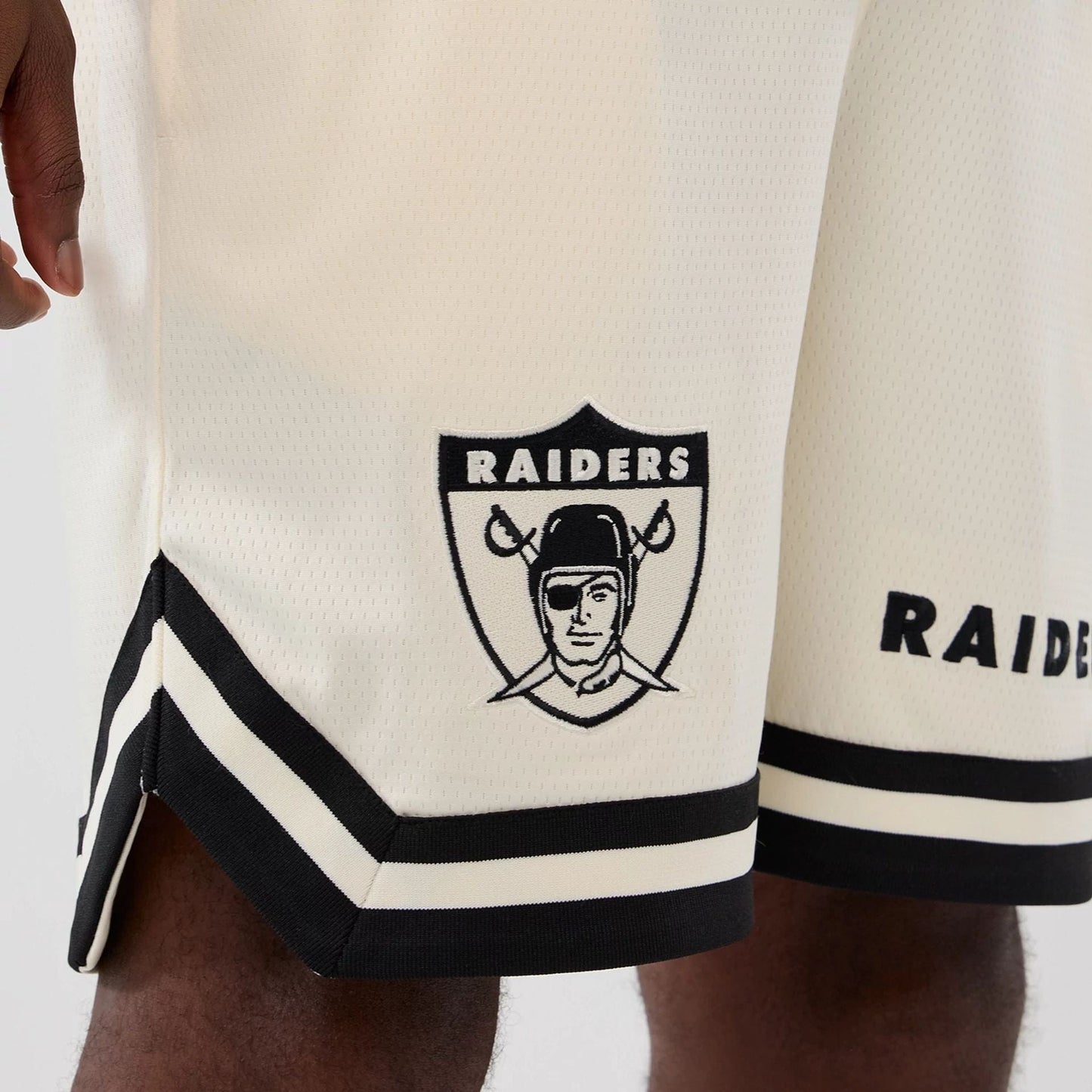 The model is wearing these NFL Historic Las Vegas Raiders shorts in cream. 5