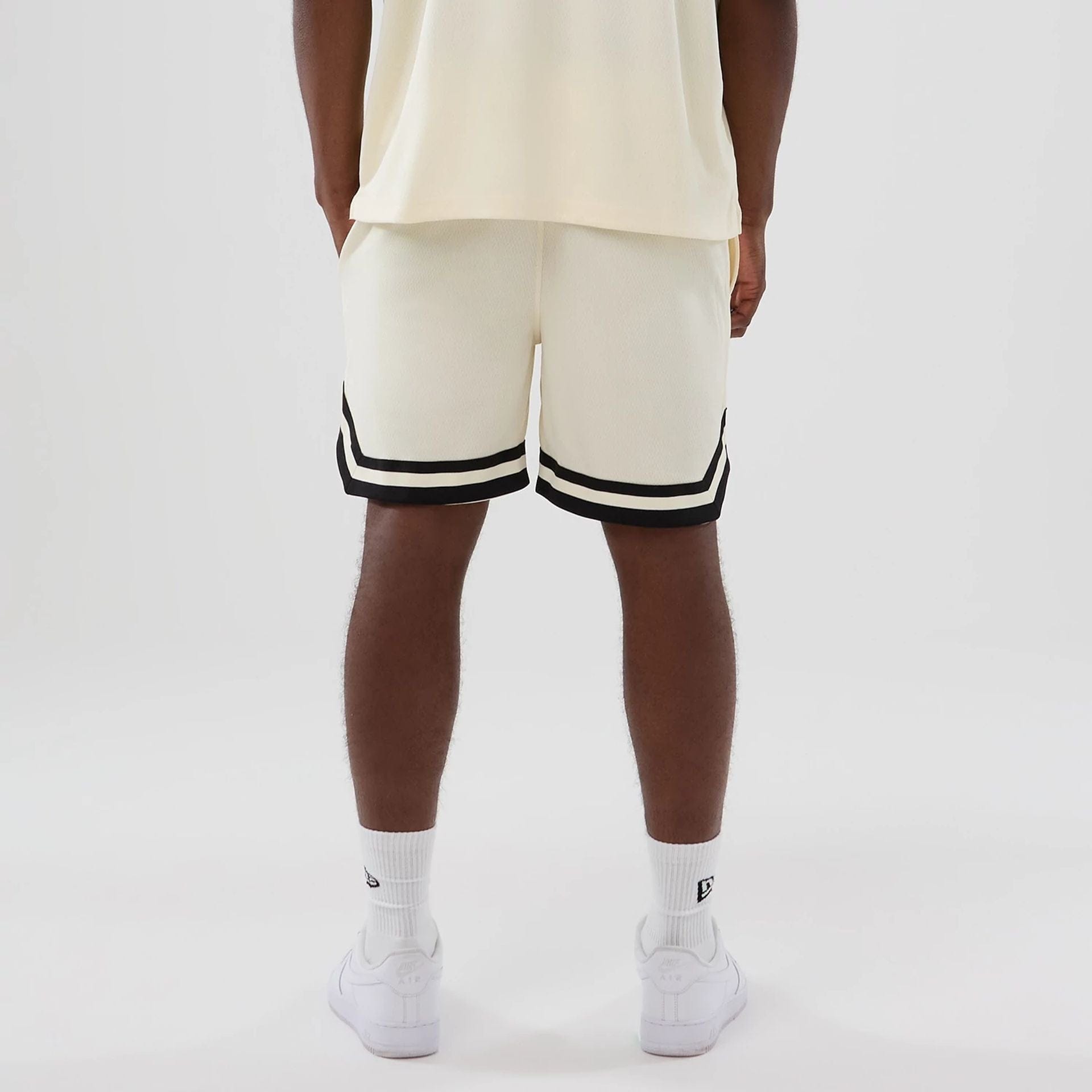 The model is wearing these NFL Historic Las Vegas Raiders shorts in cream. 2