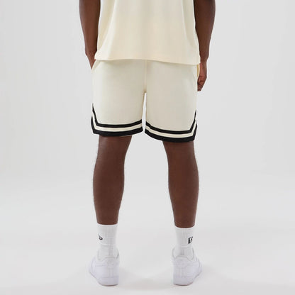 The model is wearing these NFL Historic Las Vegas Raiders shorts in cream. 2