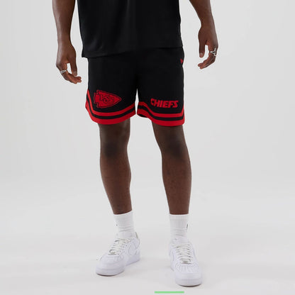 The model is wearing these NFL Historic Kansas City Chiefs shorts in black. 1