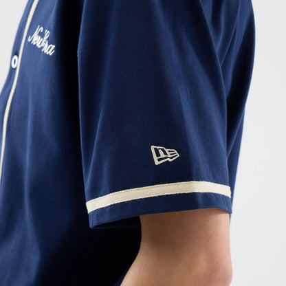 The model is wearing this New Era Oceanside Jersey in blue. 4