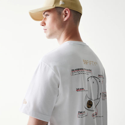 59FIFTY Fitted Cap Description Graphic White T-Shirt, on-model view showing the back of the white T-shirt with graphic illustrations of cap details in black and red, New Era logo embroidered on the left sleeve, and worn with a beige cap.