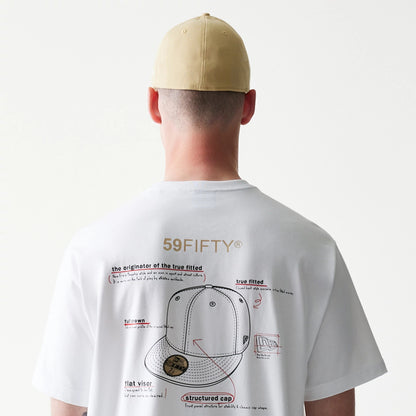 59FIFTY Fitted Cap Description Graphic White T-Shirt, rear view showing the graphic print with detailed instructions for a cap on the back, worn by a model in a beige cap that features a row of eyelets.