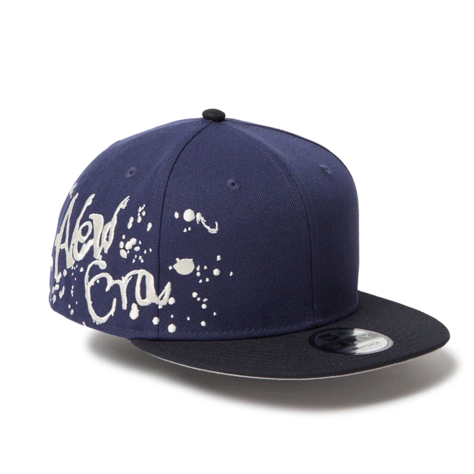 This is a New Era Dripping Emblem Navy 9FIFTY Snapback Adjustable Cap 1