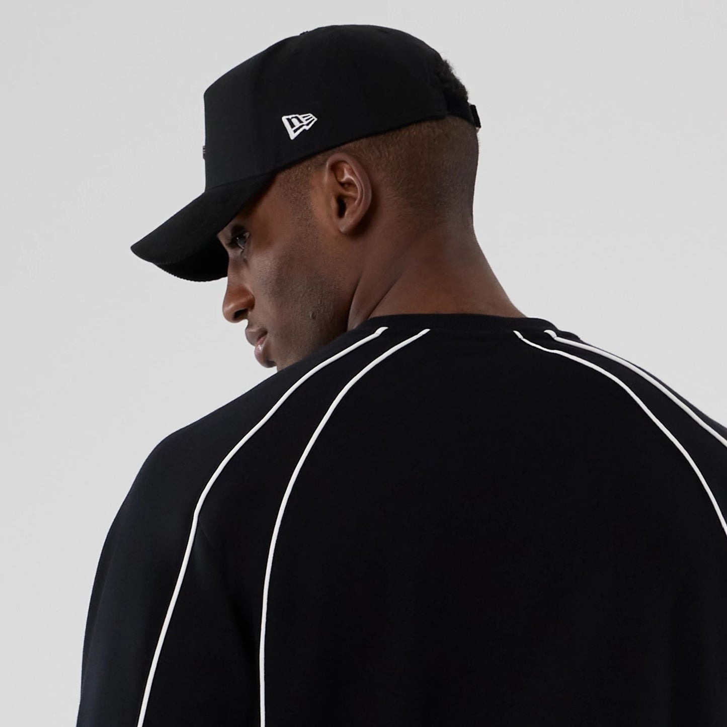 The Male model is wearing New Era Colour Block Black Crew Neck Sweater 6
