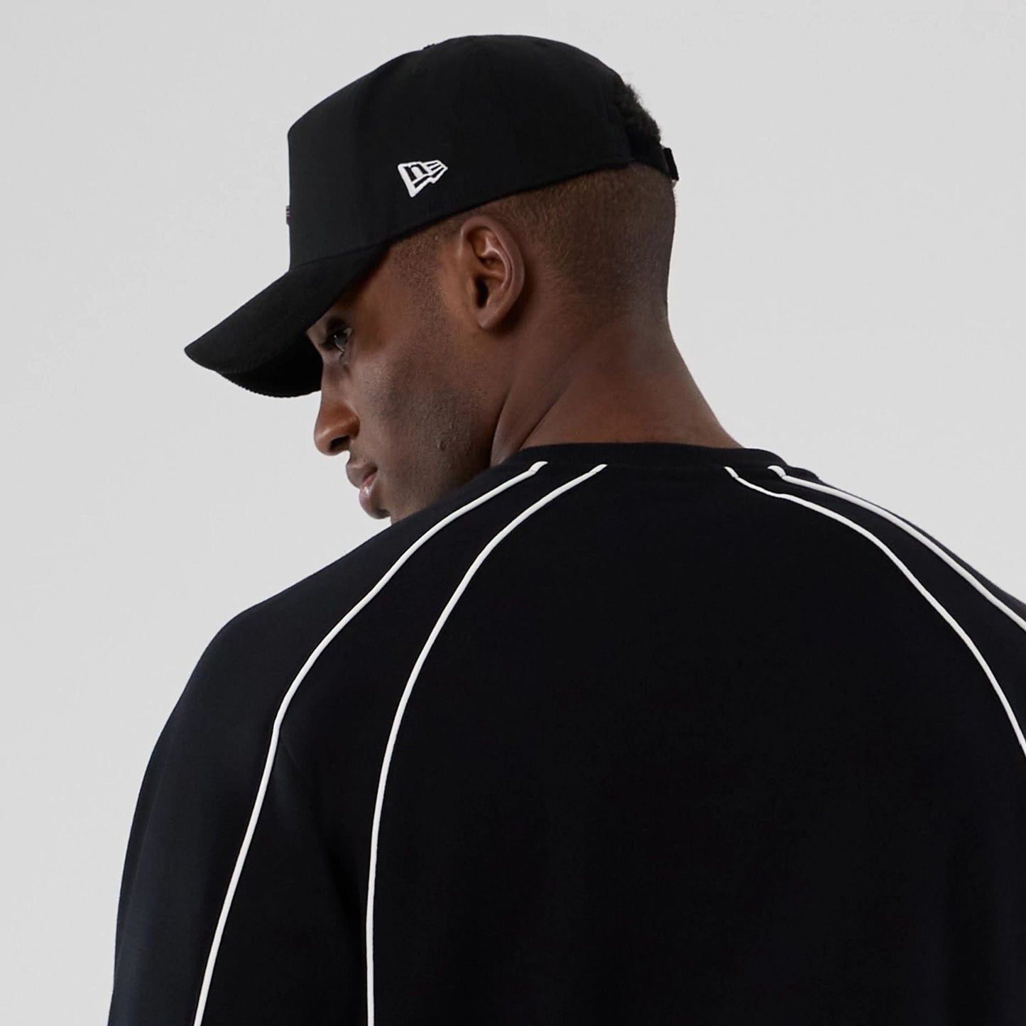 The Male model is wearing New Era Colour Block Black Crew Neck Sweater 6