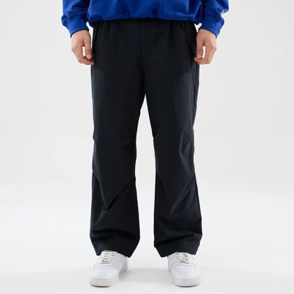 The Male model is wearing New Era Organic Black Parachute Trousers 1