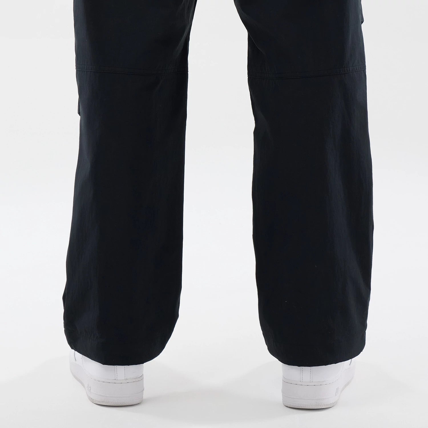 The Male model is wearing New Era Organic Black Parachute Trousers 7