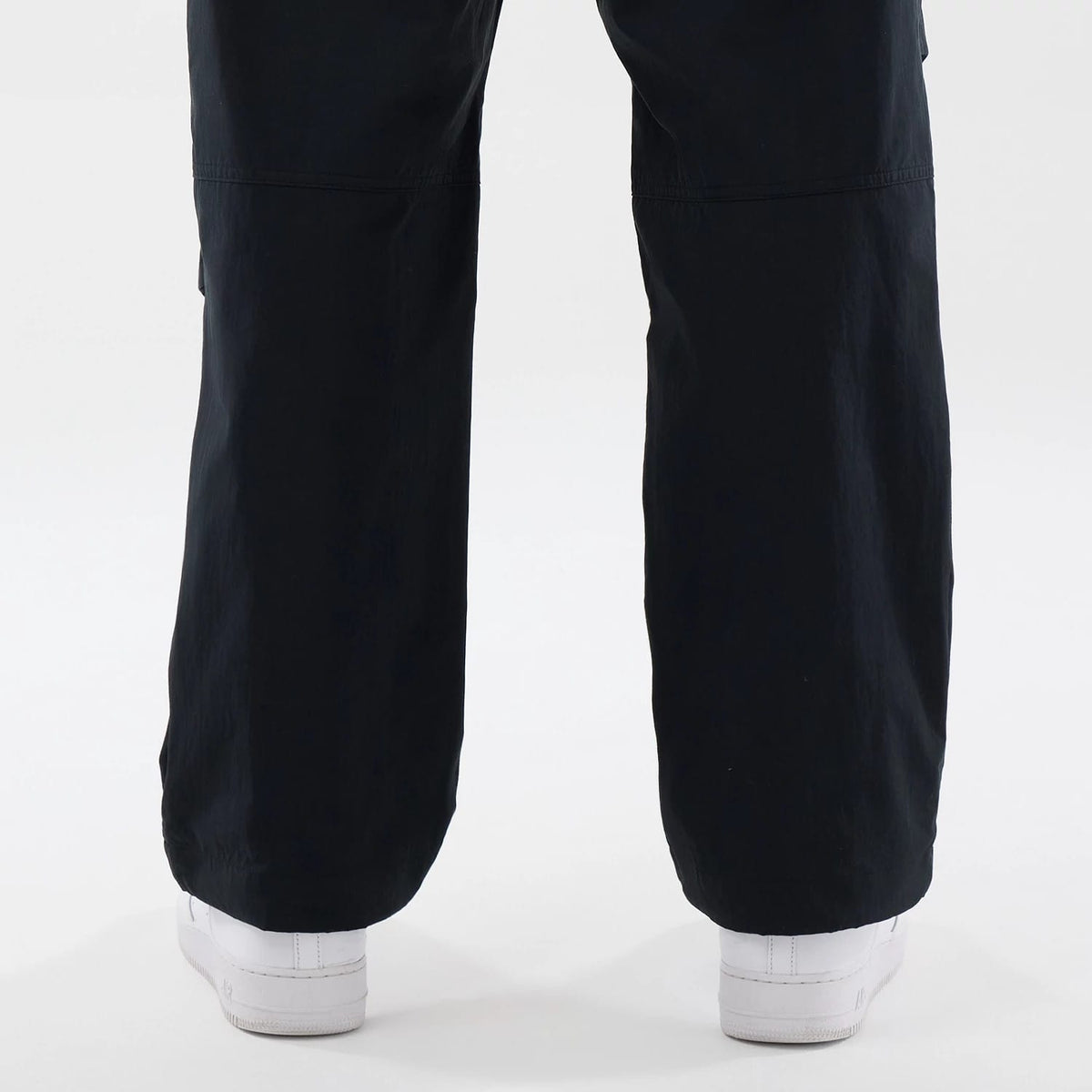 The Male model is wearing New Era Organic Black Parachute Trousers 7