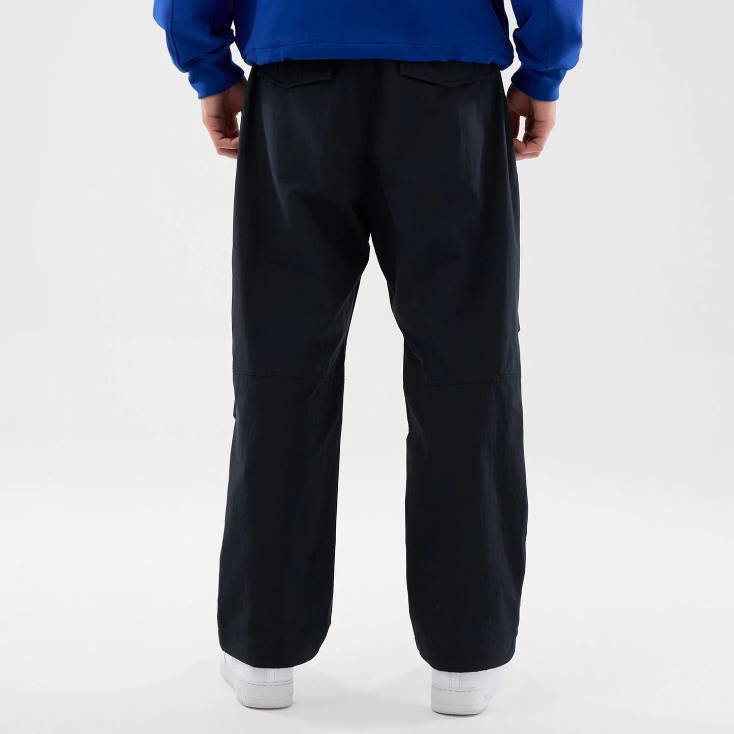 The Male model is wearing New Era Organic Black Parachute Trousers 2