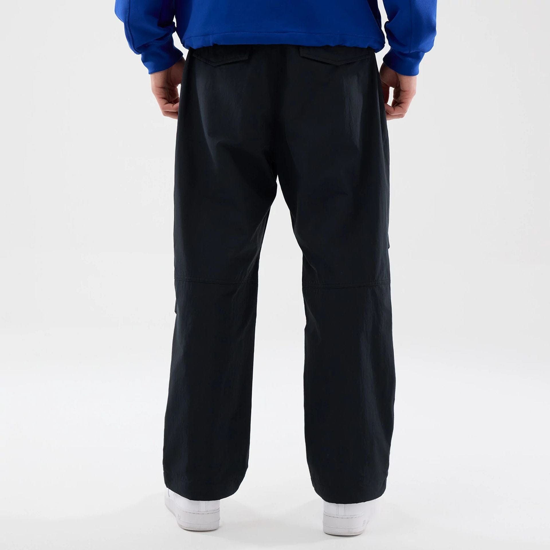 The Male model is wearing New Era Organic Black Parachute Trousers 2