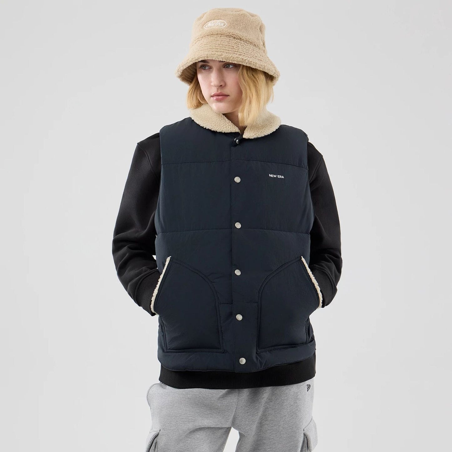 The Male model is wearing  New Era Organic Boa Neck Navy Gilet  4