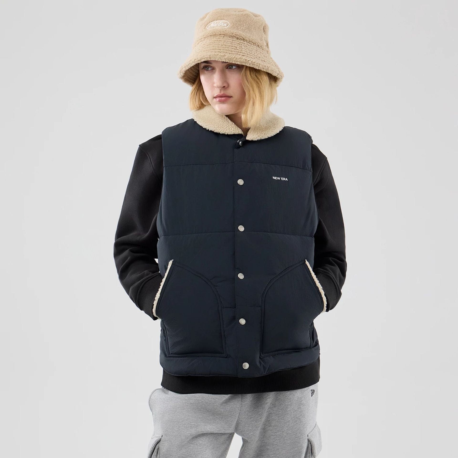 The Male model is wearing  New Era Organic Boa Neck Navy Gilet  4