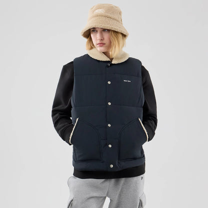 The Male model is wearing  New Era Organic Boa Neck Navy Gilet 4