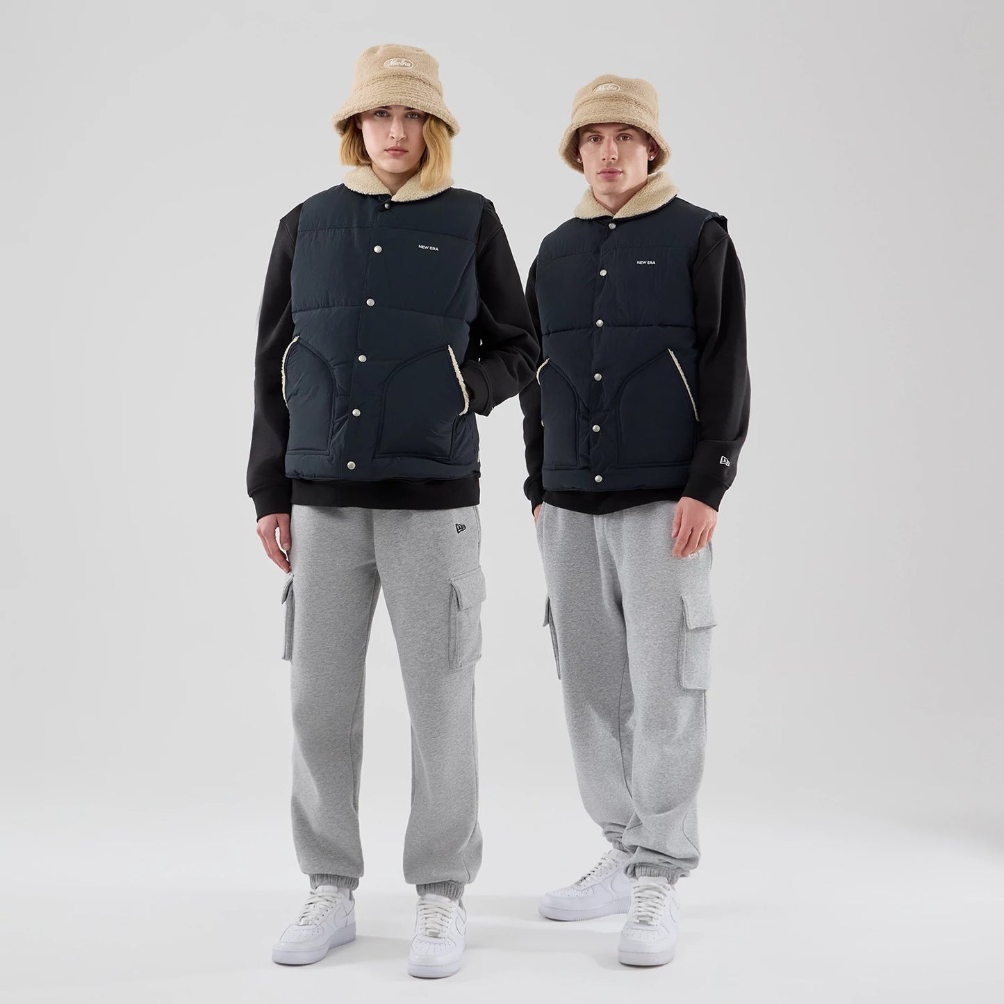 The Male model is wearing  New Era Organic Boa Neck Navy Gilet 1