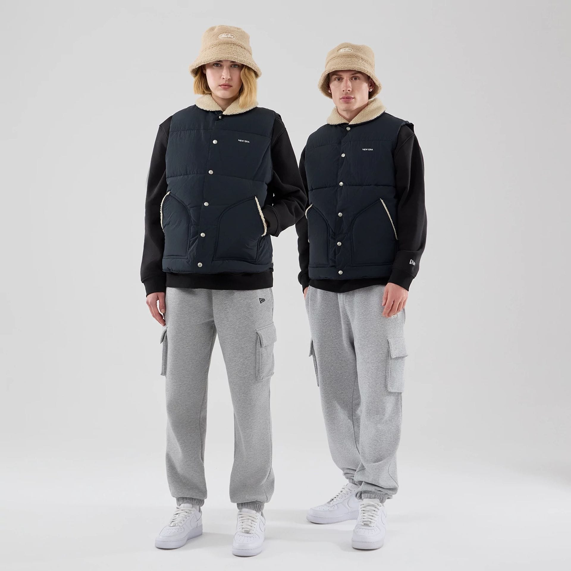 The Male model is wearing  New Era Organic Boa Neck Navy Gilet 1