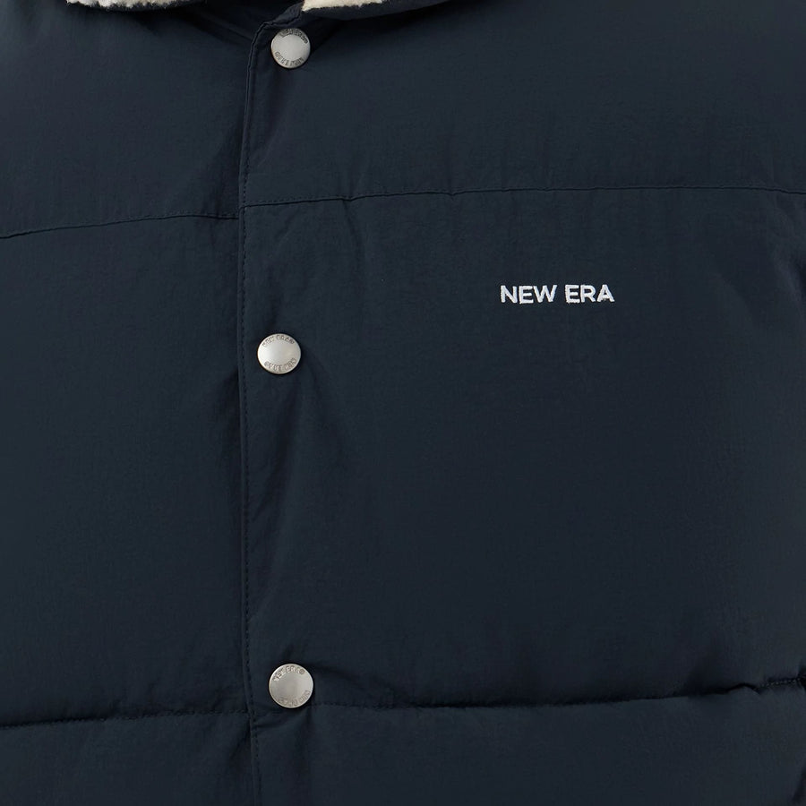 The Male model is wearing  New Era Organic Boa Neck Navy Gilet  6