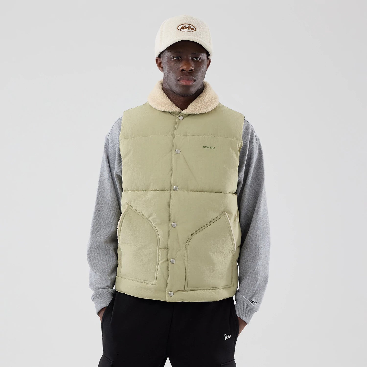 The Male model is wearing  New Era Organic Boa Neck Khaki Gilet 3