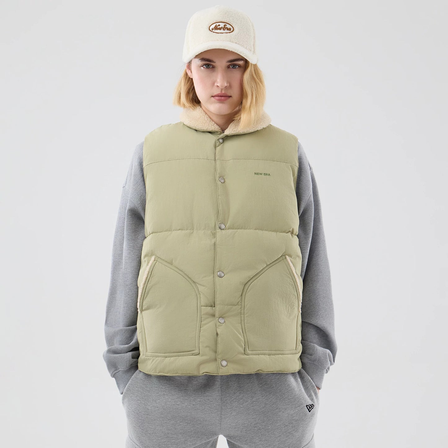 The Male model is wearing  New Era Organic Boa Neck Khaki Gilet 8