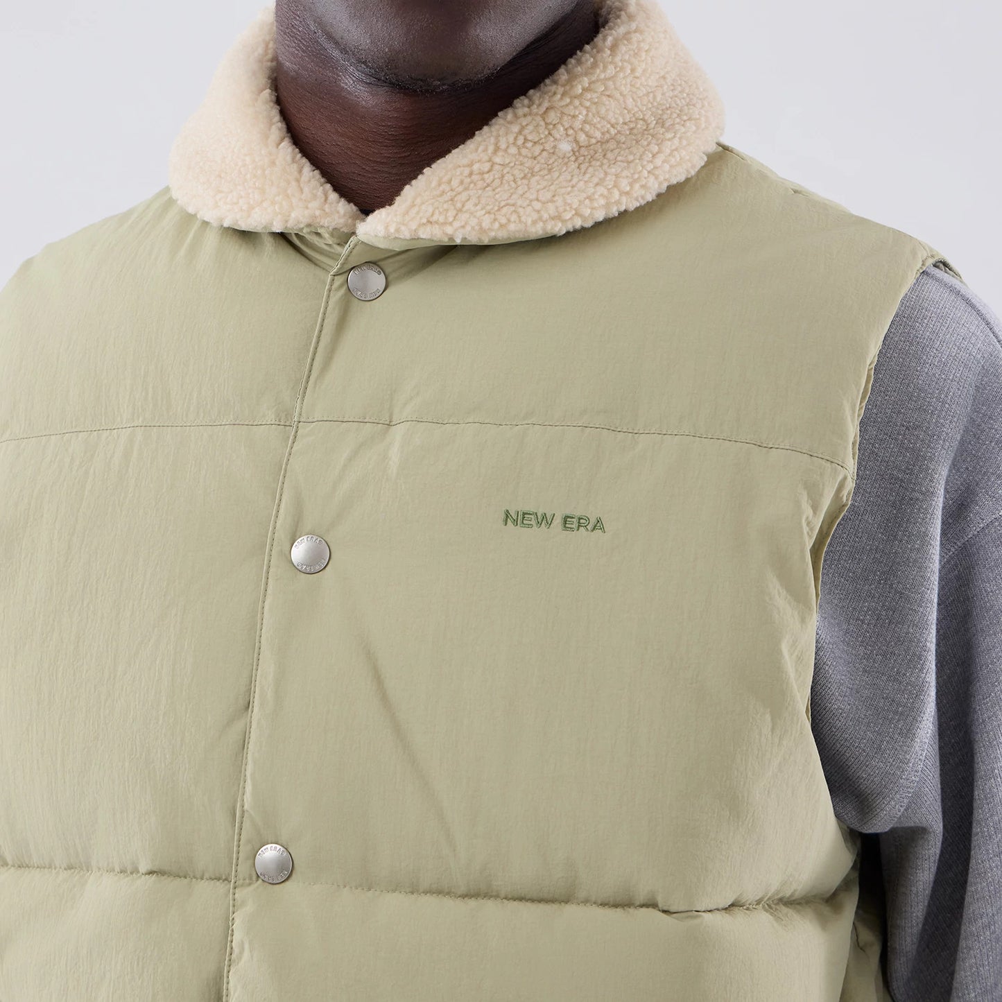 The Male model is wearing  New Era Organic Boa Neck Khaki Gilet 4