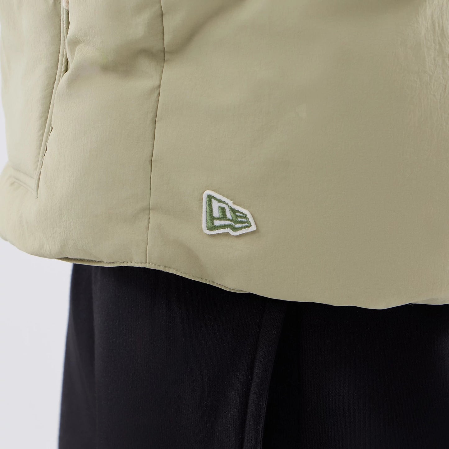 The Male model is wearing  New Era Organic Boa Neck Khaki Gilet 6