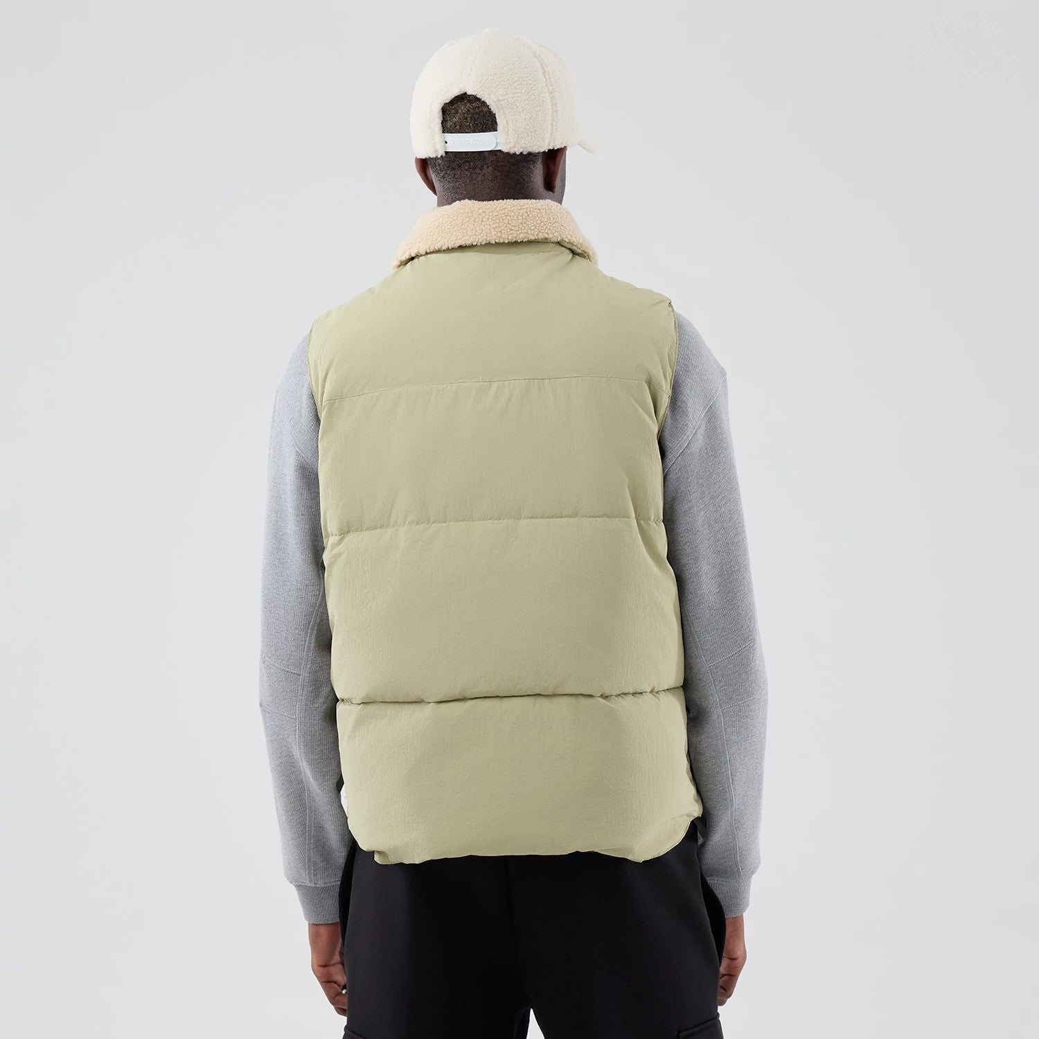 The Male model is wearing  New Era Organic Boa Neck Khaki Gilet 2