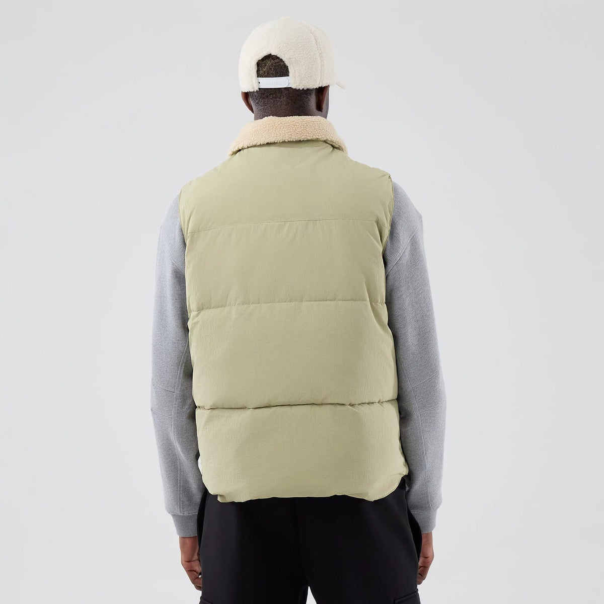 The Male model is wearing  New Era Organic Boa Neck Khaki Gilet 2