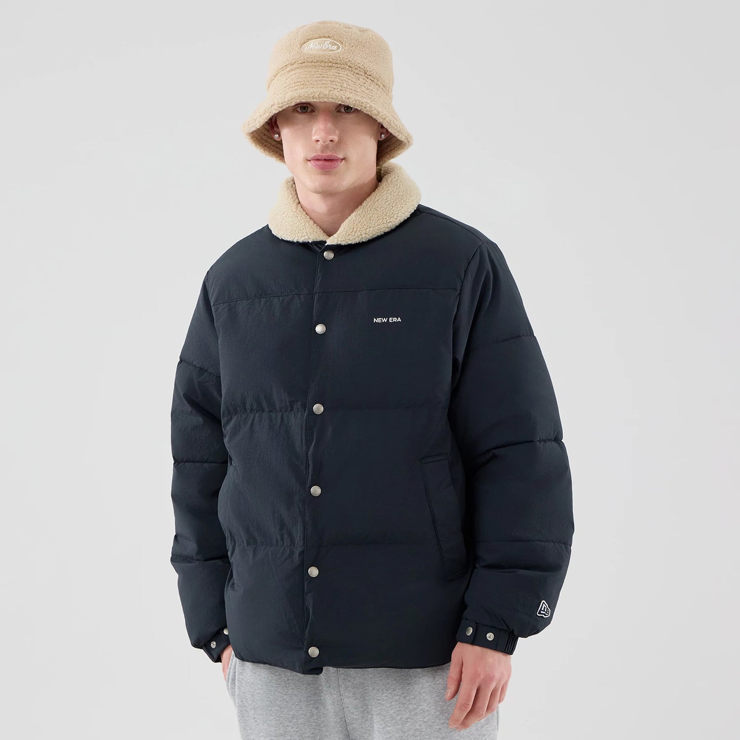 The Male model is wearing  New Era Organic Boa Neck Navy Jacket 3
