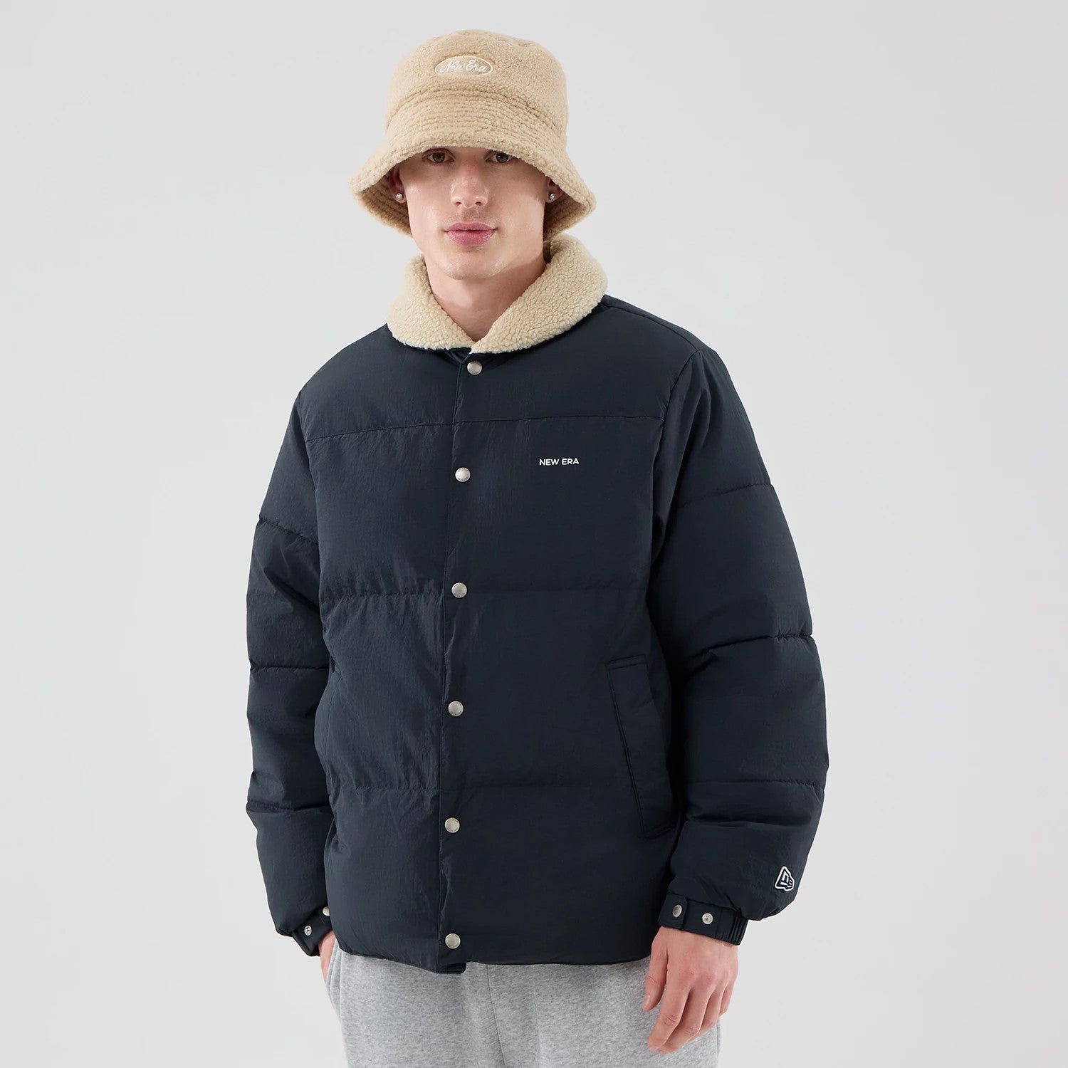 The Male model is wearing  New Era Organic Boa Neck Navy Jacket 3