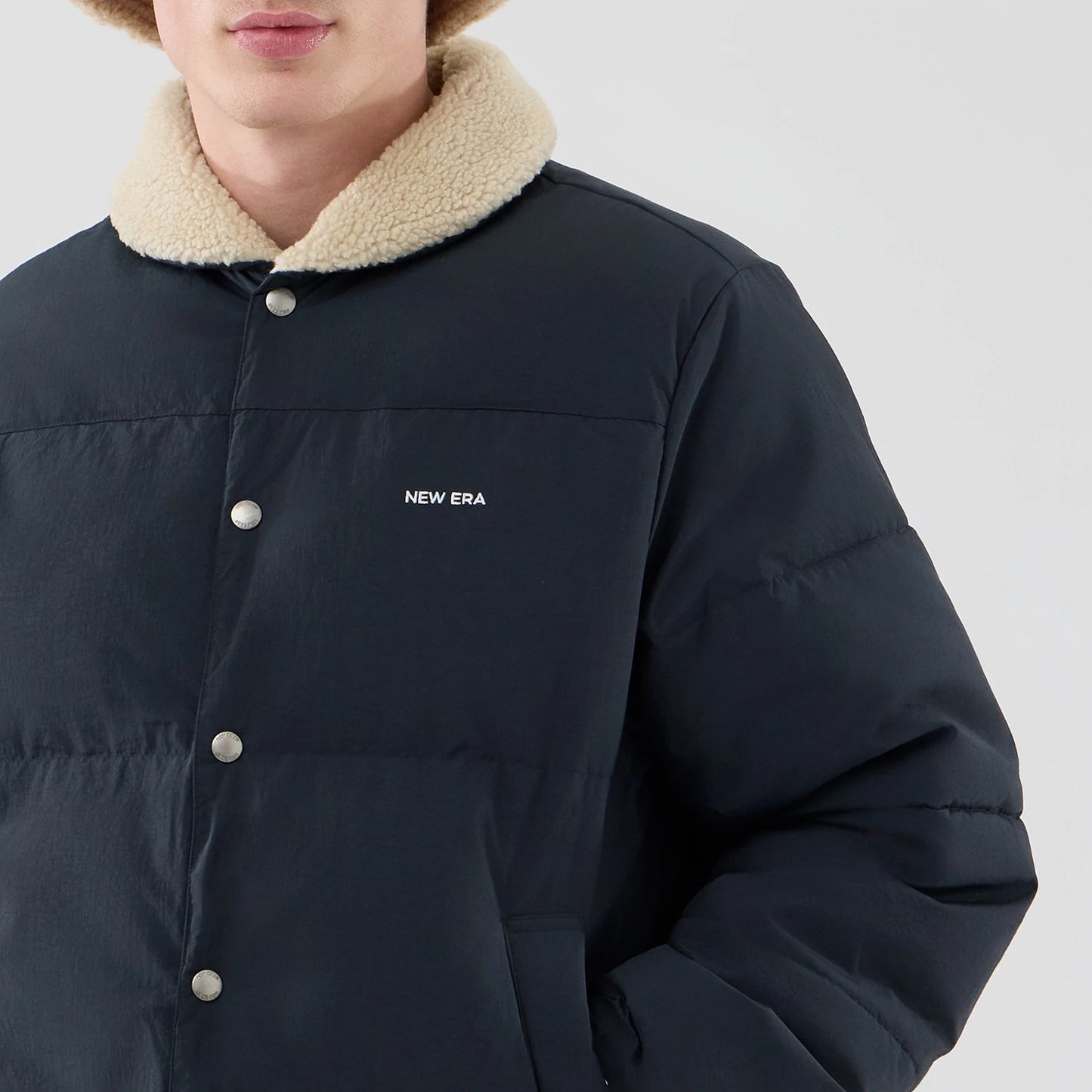 The Male model is wearing  New Era Organic Boa Neck Navy Jacket 5
