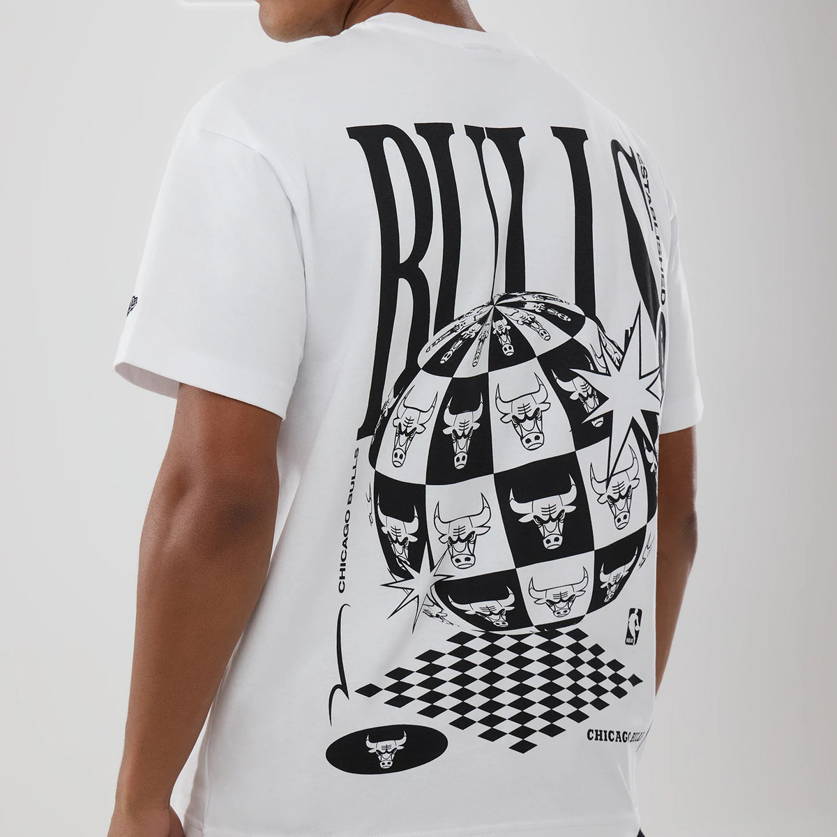 Chicago Bulls NBA World White T-Shirt, rear view showing bold black lettering and a large black and white globe graphic incorporating the Bulls logo in a chequered pattern across the centre back.