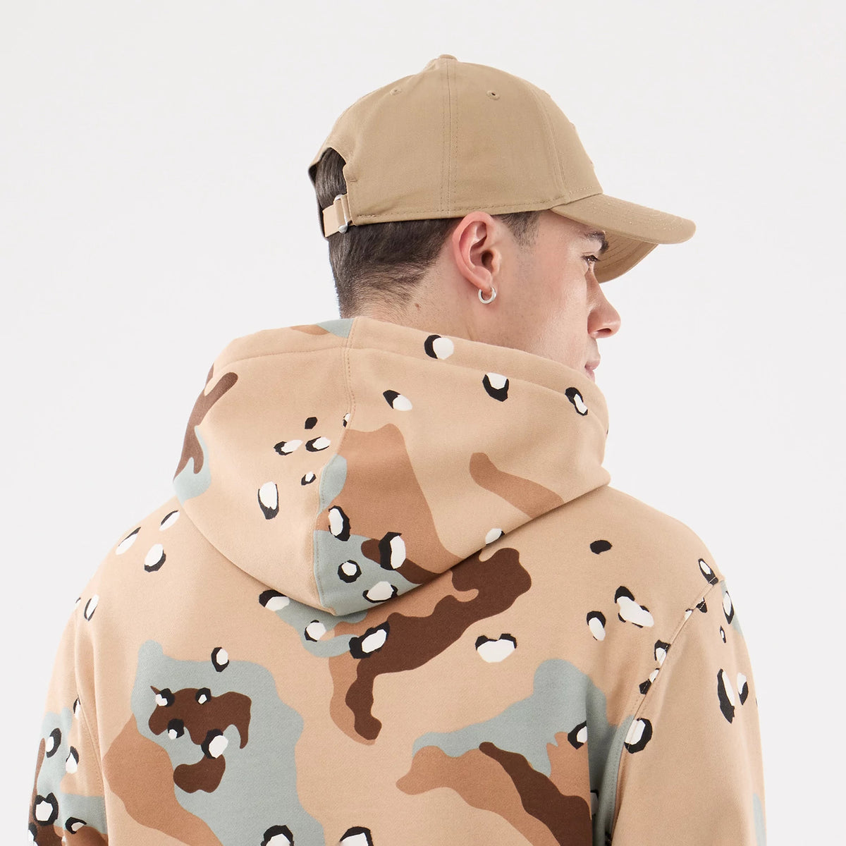 New York Yankees MLB Desert Camo 2 Way Full Zip Hoodie, rear view showing the desert camo pattern on the hood and back, worn by a person in a tan cap with eyelets and an adjustable strap at the back.