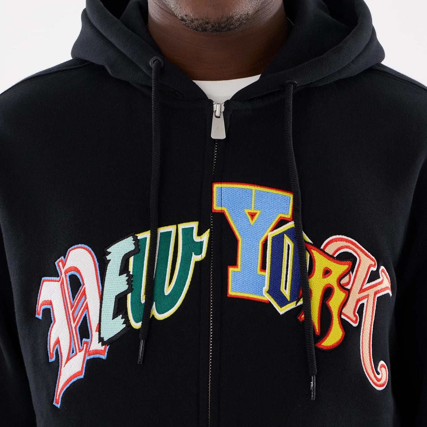 The model is wearing this MLB Word Art New York Yankees 2 Way Full Zip Hoodie in black. 4