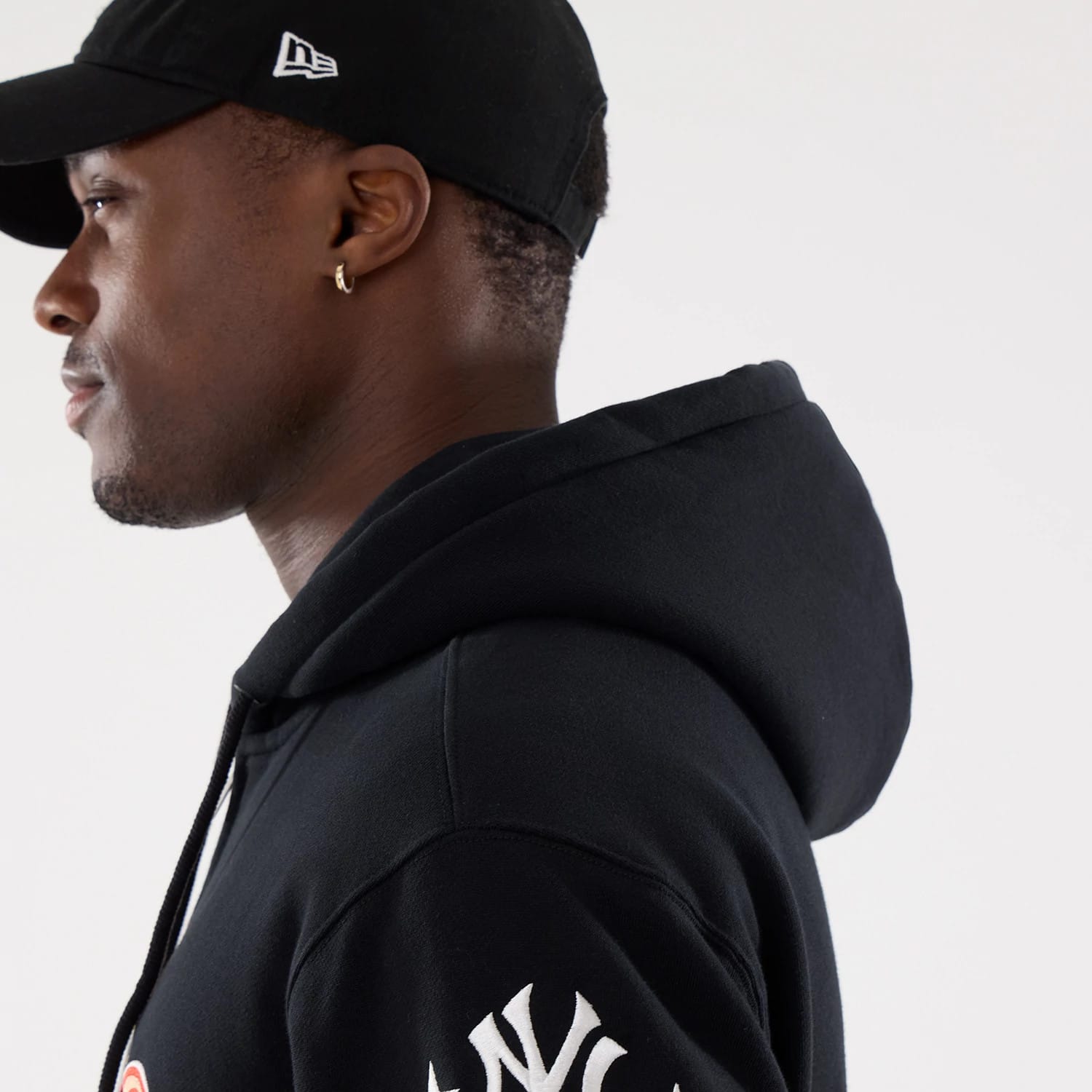 The model is wearing this MLB Word Art New York Yankees 2 Way Full Zip Hoodie in black. 7