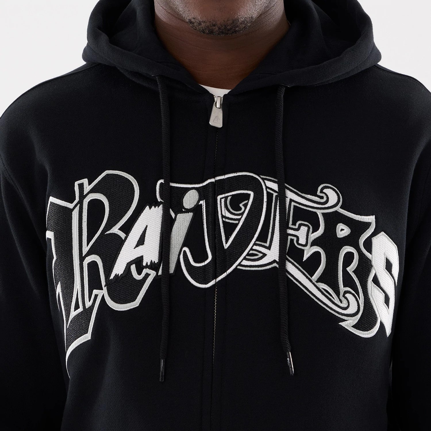 The model is wearing this MLB Word Art Las Vegas Raiders 2 Way Full Zip Hoodie in black. 4