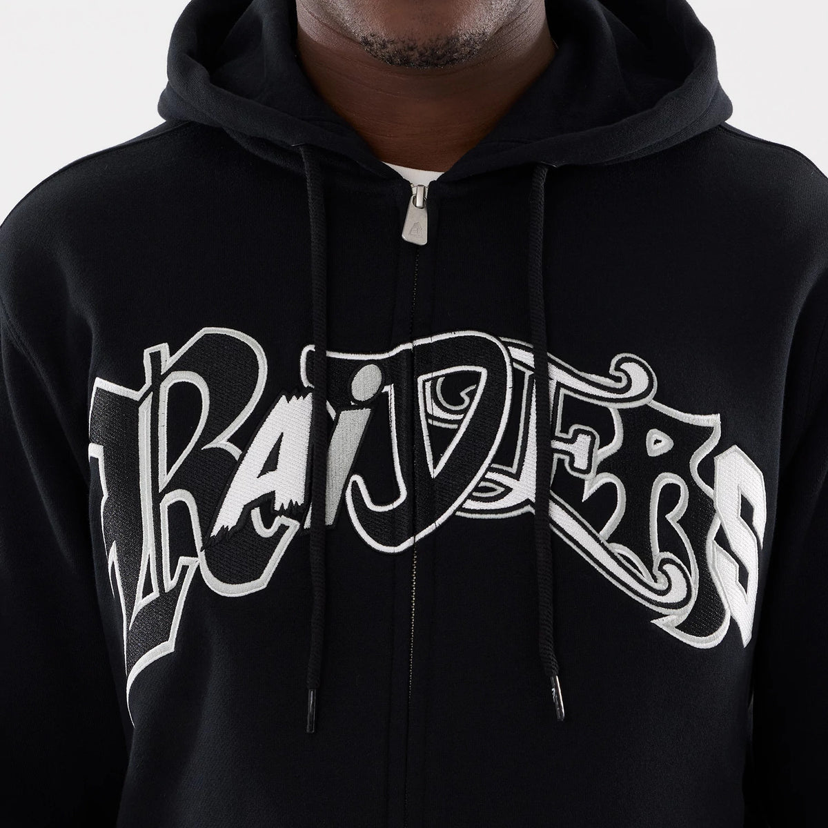 The model is wearing this MLB Word Art Las Vegas Raiders 2 Way Full Zip Hoodie in black. 4