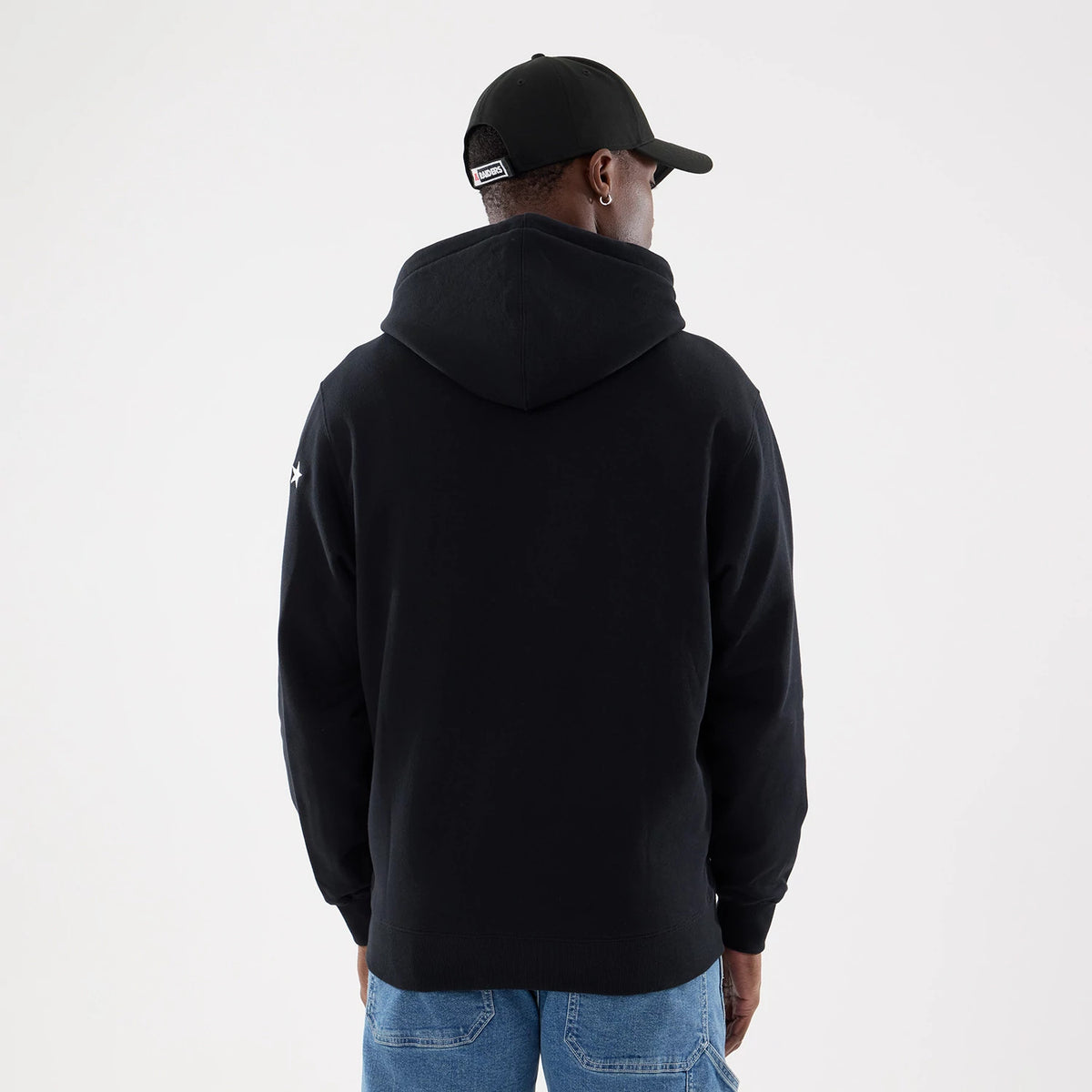 Las Vegas Raiders NFL Word Art Black 2 Way Full Zip Hoodie, rear view showing the plain black back with a generous hood, a small white star on the right sleeve, and a black cap with a white debossed New Era logo at the back.